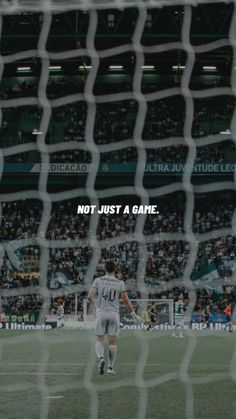 a soccer goalie looking at the ball in front of him and saying not just a game