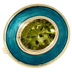 Rooted in clean, classic lines, this bold yet elegant ring reflects the individuality of the wearer. The crisp green Peridot glistens next to the turquoise vitreous hot enamel, transporting us back to a tropical island ocean. Peridot one of the oldest mined stones from as early as 1500 BC is packed with positive energy giving the wearer a sense of well being like a sun kissed summer day. Celebrating my love for colour and the venerable technique of enameling I am so pleased to present my signatu Elegant Green Enamel Ring With Polished Finish, Elegant Green Enamel Ring, Classic Green Enamel Jewelry, Formal Green Enamel Jewelry, Elegant Green Enamel Gemstone Ring, Green Oval Enamel Ring For Formal Occasions, Formal Green Enamel Ring With Polished Finish, Formal Oval Green Enamel Ring, Formal Green Oval Enamel Ring