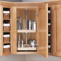 an open cabinet with various kitchen items in it