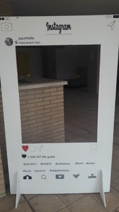 an instagram photo frame sitting on the ground in front of a brick wall and floor