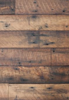 an old wooden wall with some wood planks on it's sides and the bottom part of the floor