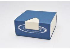 a small blue box with a white house on the top and an opening in the middle