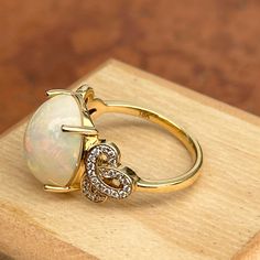 Very large statement ring! Vintage 18KT yellow gold cabochon opal and diamond filigree design ring. Size 7.75 Can be resized for an additional fee Stone measures: 13.9mm x 11.9mm Stamped 18k & iliana .40 ct natural diamonds; SI/ H-I Very Good Condition Luxury Oval Cabochon Opal Ring For Formal Occasions, Gold Teardrop Opal Ring Perfect For Gifts, Formal Opal Rings With Gemstone Accents, Luxury Cabochon Opal Promise Ring, Elegant Opal Ring With Oval Cabochon And Accent Stones, Elegant Oval Cabochon Opal Ring With Accent Stones, Gold Teardrop Opal Ring Gift, Luxury Oval Cabochon Opal Promise Ring, Gift Opal Ring With Diamond Accents