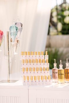 bottles of perfume sitting on top of a white table