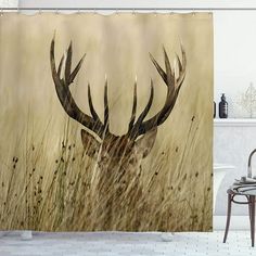 a shower curtain with an image of a deer in tall grass