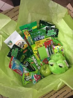 a green bag filled with candy and snacks