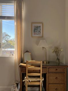 a wooden desk with a chair next to it and a lamp on top of it