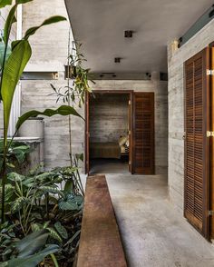 an open door leading to a bedroom with wooden shutters on the walls and floor