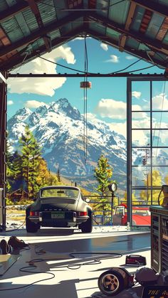 a car is parked in front of an open garage door with mountains in the background