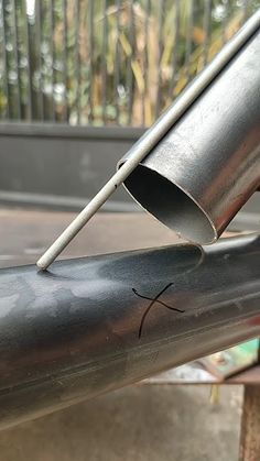 a close up of a metal pipe with a stick sticking out of it's end