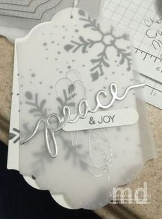 a close up of a snowflaked card with the word peace on it