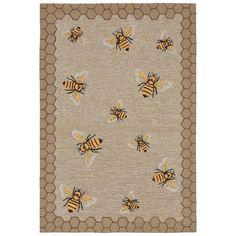 a rug with bees on it and honeycombs around the edges, in beige