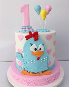 a birthday cake decorated with an angry bird and number one on the top, sitting on a plate