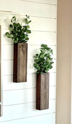 two wooden planters are hanging on the wall