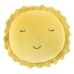 a yellow sun pillow with eyes closed