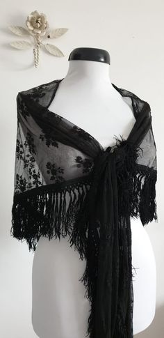 "Vintage 1930s black lace shawl with floral embroidery and black fringe. ....M E A S U R E M E N T.... 101\" in full width 25\" from center of straight edge to tip of fringe 4\" fringe brand/maker: n/a condition; excellent( see last photo ) Shipping Is Avaliable Worldwide. Every item is carefully shipped Priority via Air Mail - shipping takes from 7 to 14 working days, depending on your location. Shipping includes Tracking. Come and check out our shop to see all items! https://www.etsy.com/shop/ Cheap Vintage Shawl, Black Ruffled Shawls, Black Lace Shawl Weddings, Crochet Lace Shawl Black, Luxury Black Bohemian Shawl, Victorian Shawl 19th Century, Black Rose Shawl, 1930s Gothic Fashion, Black Lace Shawl