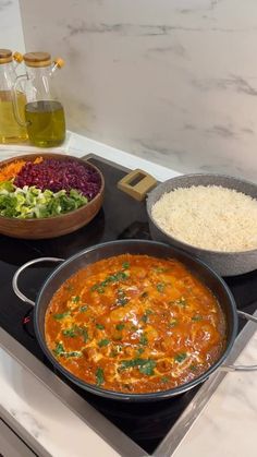 an image of food being cooked on the stove top with vegetables and rice in bowls