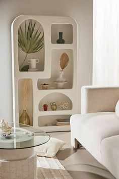 a living room filled with furniture and a glass table in front of a white couch