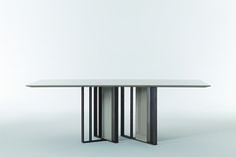 a white table with two metal legs and a square shaped dining table in the middle