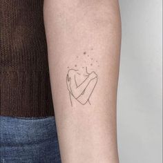 a woman's arm with a small tattoo on the left side of her arm