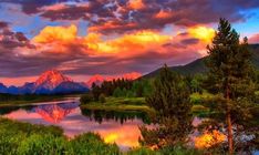 the mountains are reflected in the water at sunset