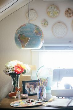 a wooden desk topped with a vase filled with flowers