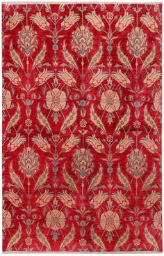 a red rug with an intricate design on the front and back side, in various colors