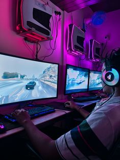 a man is playing a video game on his computer screen while sitting in front of two monitors