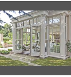 a white house with glass doors and windows