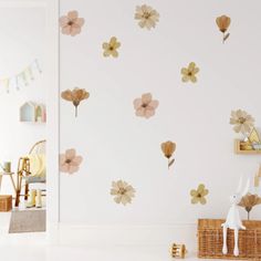 a white room with flowers on the wall and a basket in front of it,