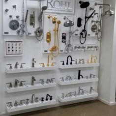 there are many different types of faucets on display in the store's wall