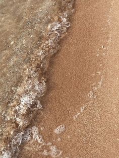 the beach is covered in waves and sand