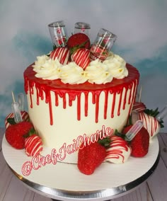 a cake decorated with strawberries and white icing