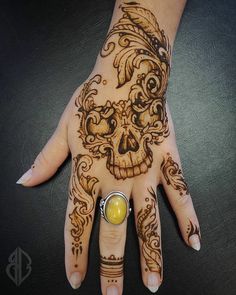 a woman's hand with a tattoo on it and a yellow ball in the middle