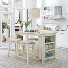 a kitchen table with two stools next to it