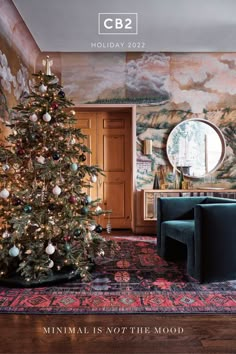 a living room with a christmas tree in the corner and other decorations on the wall