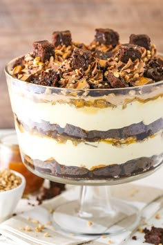 a layered dessert with nuts and chocolate on top