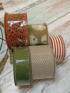 four rolls of washi tape sitting on top of a wooden table next to each other