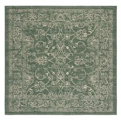 a green rug with an intricate design on the front and back side, in white