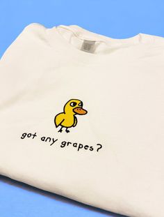 "got any grapes? Duck Shirt/Sweatshirt/Hoodie got any grapes? Inspired by the iconic \"Duck Song\". Made of a premium quality cotton blend for a great quality soft feel, and comfortable retail fit. Our embroidery is crafted for long-lasting quality so your garment stays looking fantastic. Fabric: Shirt: 100 % Cotton Sweatshirt: 50% Cotton 50% Polyester Hoodie: 80% Cotton 20% Polyester Weight: Shirt: 180 GSM Sweatshirt and Hoodie: 280 gsm Shop With Total Confidence - If something's not quite righ Got Any Grapes Duck, Cute Funny Sweatshirts, Fun Clothes Aesthetic, Duck Things To Buy, Fun Merch Ideas, Painting On Sweatshirts, Thrift Sweatshirts, Cricut Clothing Projects, Simple Sweatshirt Design