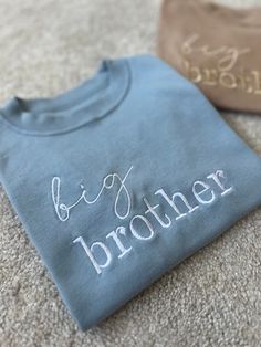 The perfect touch to reveal your new arrival to a sibling 🫶🏼 Perfect to get the older siblings excited about their new arrival!  When I was pregnant with my second son, my son loved wearing his big brother tshirt proudly and was so excited when he read it himself to find out about his new baby sibling 🤍 Can also be made to say 'big sister' aswell as 'little brother' or 'little sister' for the baby to match 🤍 (Please see other listings in my shop as I can't have them all under one item!) 100% Upgraded To Big Brother, Big Brother Embroidered Shirt, Personalized Crew Neck T-shirt For Gender Reveal, Blue T-shirt For Gender Reveal On Father's Day, Blue T-shirt For Father's Day Gender Reveal, Older Sibling Pregnancy Announcement, Baby Brother Announcement, Big Brother Shirt Announcement, Pregnancy Announcement Surprise