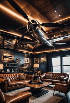 a living room with leather couches and a ceiling fan in the middle of it