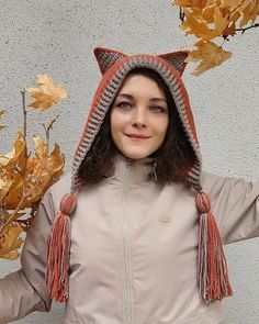 a woman wearing a knitted cat hat