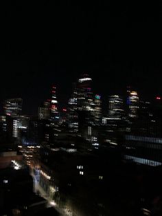 the city skyline is lit up at night