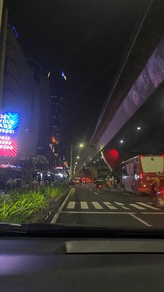 a city street at night with traffic lights