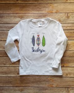 This boy fishing applique shirt is perfect for the little boy in your life who loves fishing.  Fishing season is coming!  He can be ready with this lure applique fishing shirt! This darling shirt is done with a vintage blanket stitch and can be personalized with his or her name. Great for the beach! The design is embroidered on a white 100% cotton, boutique quality shirt or a basic baby bodysuit. Please message me with any custom request prior to purchasing.  Be sure to list name or monogram (if desired) in personalization box when ordering. All embroidered items are finished with a soft backing to protect sensitive skin from scratchy stitches. Wash inside out on gentle cycle and hang to dry. Do not use bleach. Iron inside out on low heat without steam.  All of our items are made in our pe Monogram Fishing Shirt, Baby Fish, Boy Fishing, Boys Tops, Vintage Blanket, Applique Shirts, This Boy, Blanket Stitch, Boys Top