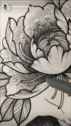 someone is drawing flowers on the paper with a pen and inking them in black and white