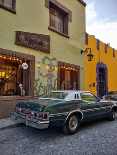 an old car parked in front of a building