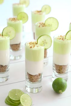 small desserts with cucumbers and lime slices on the side are arranged in individual cups