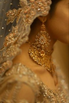 a close up shot of a bride's veil and earrings